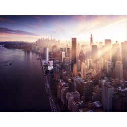 New York City - beautiful colorful sunset over manhattan fit sunbeams between buildings